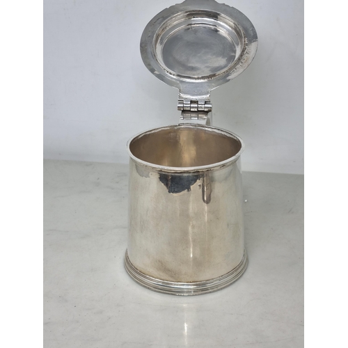 216 - A William & Mary silver Tankard with flat cover, vollute thumb piece, scroll handle engraved initial... 