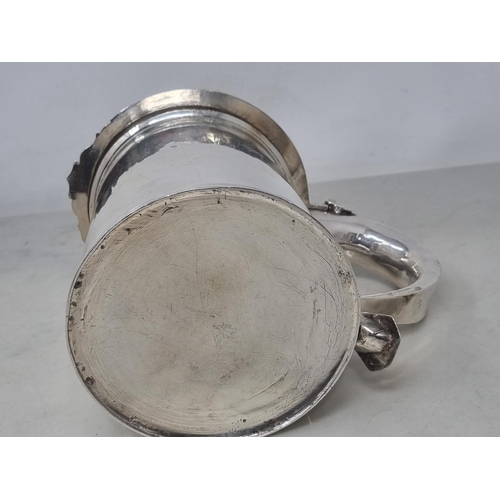 216 - A William & Mary silver Tankard with flat cover, vollute thumb piece, scroll handle engraved initial... 