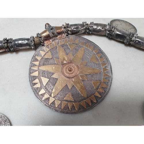 223 - A Middle eastern white metal Dowry Necklace mounted with seven re-strike Austria Maria Theresa silve... 