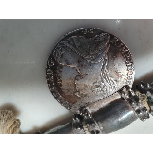 223 - A Middle eastern white metal Dowry Necklace mounted with seven re-strike Austria Maria Theresa silve... 