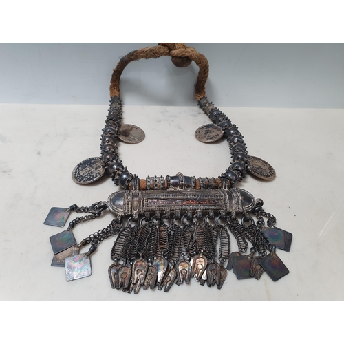 224 - A Middle eastern white metal Dowry Necklace mounted with four re-strike Austria Maria Theresa silver... 