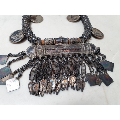 224 - A Middle eastern white metal Dowry Necklace mounted with four re-strike Austria Maria Theresa silver... 