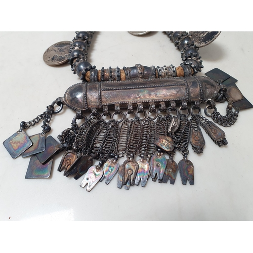 224 - A Middle eastern white metal Dowry Necklace mounted with four re-strike Austria Maria Theresa silver... 