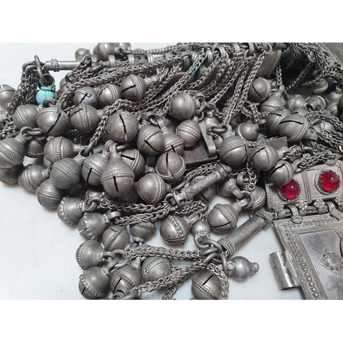 227 - A Middle Eastern Omani white metal Panel belt with pendant bell and red paste decoration, 90cms, wei... 
