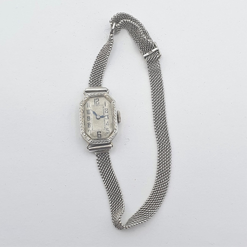251 - An Art Deco lady's Wristwatch by Gübelin, the white metal elongated octagonal case having silvered d... 