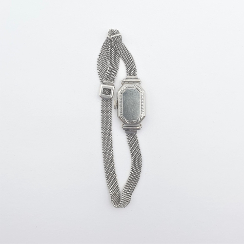 251 - An Art Deco lady's Wristwatch by Gübelin, the white metal elongated octagonal case having silvered d... 