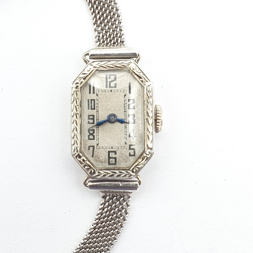 251 - An Art Deco lady's Wristwatch by Gübelin, the white metal elongated octagonal case having silvered d... 