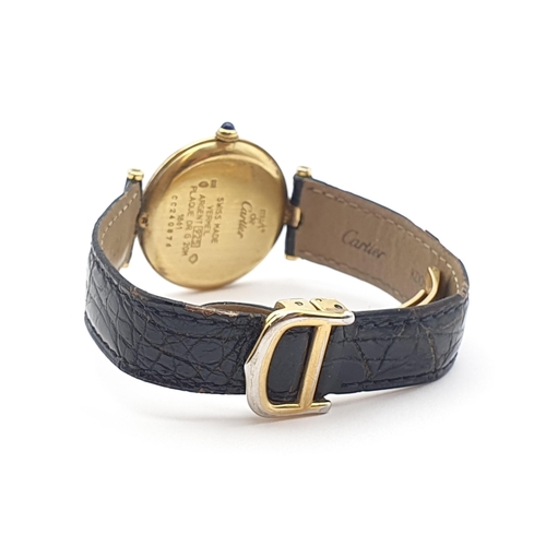 254 - A Must de Cartier lady's Wristwatch, the circular white enamel dial having Arabic numerals in a gold... 