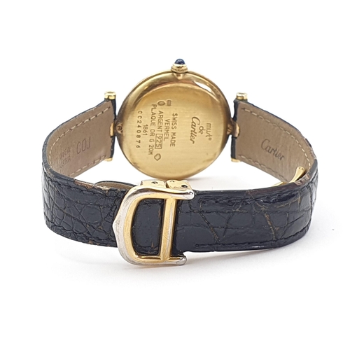 254 - A Must de Cartier lady's Wristwatch, the circular white enamel dial having Arabic numerals in a gold... 