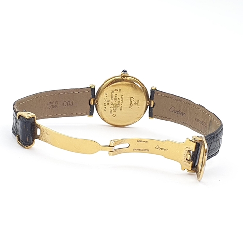 254 - A Must de Cartier lady's Wristwatch, the circular white enamel dial having Arabic numerals in a gold... 