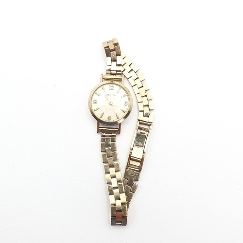 258 - A lady's Zenith Wristwatch, the round cream dial with Arabic numerals at quarters the remainder bato... 