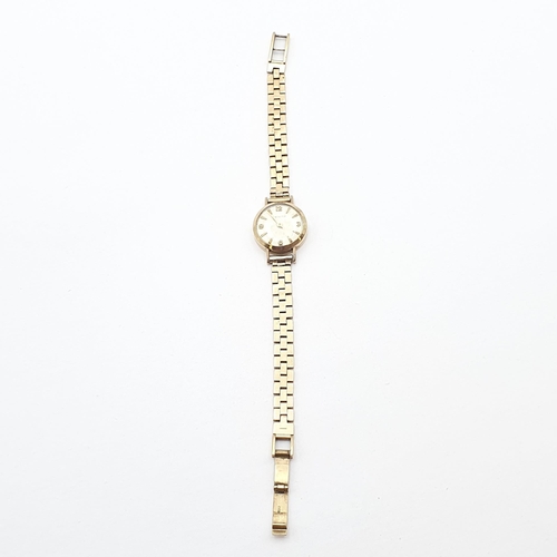 258 - A lady's Zenith Wristwatch, the round cream dial with Arabic numerals at quarters the remainder bato... 