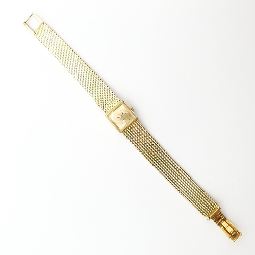 252 - A lady's Omega manual-wind Wristwatch the square champagne dial with baton markers on integral 18ct ... 