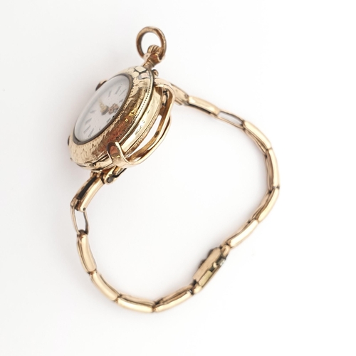 255 - A continental Lady's Fob Watch, the white enamel dial having Roman numerals and Louis XVI gold hands... 
