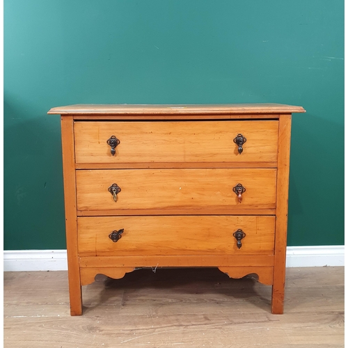 403 - A Satinwood chest of three long drawers raised on square supports with a shaped apron, 2ft 7