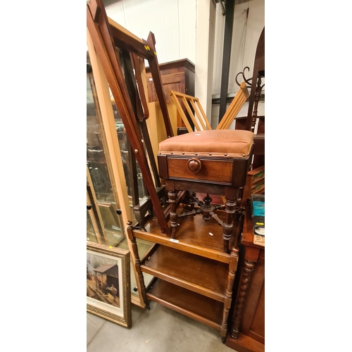 402 - A Mahogany upholstered footstool, a tea trolley, a miniature easel and a butlers tray stand. (R3)