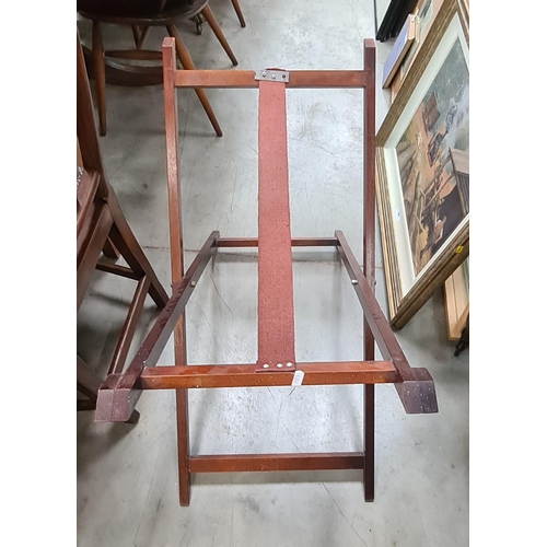 402 - A Mahogany upholstered footstool, a tea trolley, a miniature easel and a butlers tray stand. (R3)