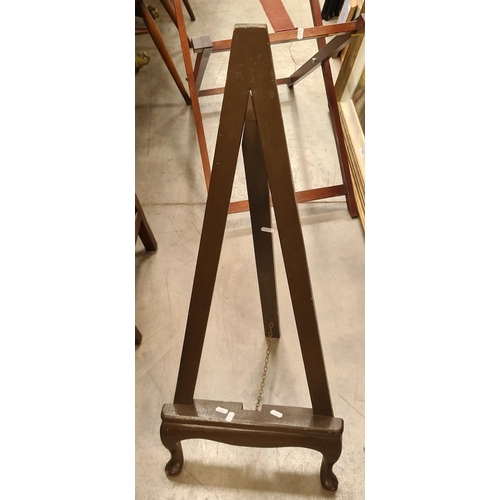 402 - A Mahogany upholstered footstool, a tea trolley, a miniature easel and a butlers tray stand. (R3)