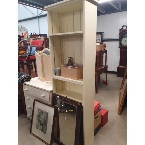 404 - A modern white painted Chest of four long Drawers, a cream dressing Mirror and a tall modern Bookcas... 