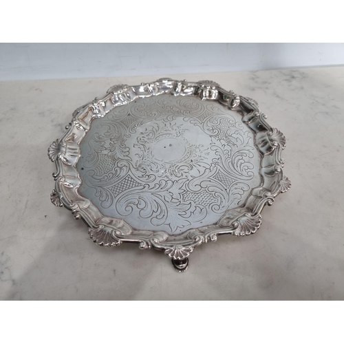 18 - A George III silver shaped circular Salver with leafage scroll engraving and scallop border, raised ... 