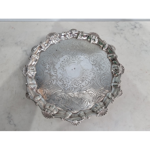18 - A George III silver shaped circular Salver with leafage scroll engraving and scallop border, raised ... 