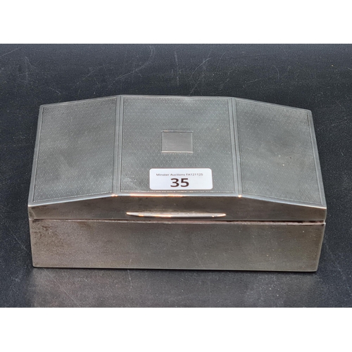 35 - A George V silver Cigarette Box with engine turned decoration, Birmingham 1927, 7 x 3 1/2in, total w... 