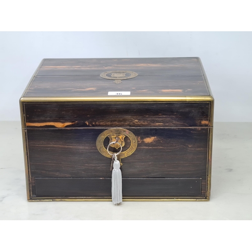 36 - An early 19th century coromandel Dressing case with brass mounts, cartouche and escutcheon, numerous... 