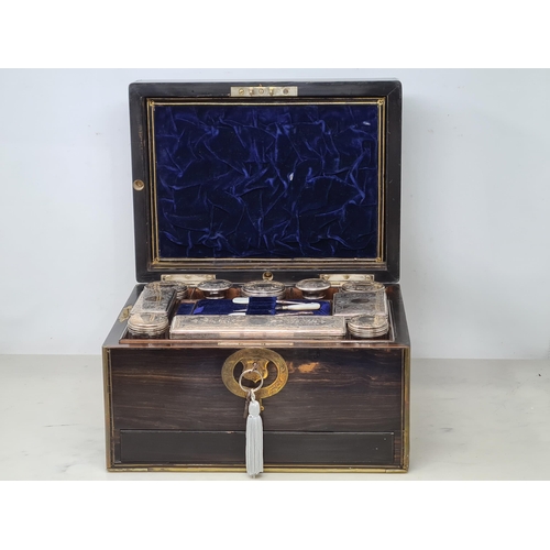 36 - An early 19th century coromandel Dressing case with brass mounts, cartouche and escutcheon, numerous... 