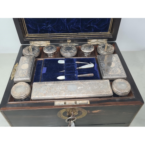 36 - An early 19th century coromandel Dressing case with brass mounts, cartouche and escutcheon, numerous... 