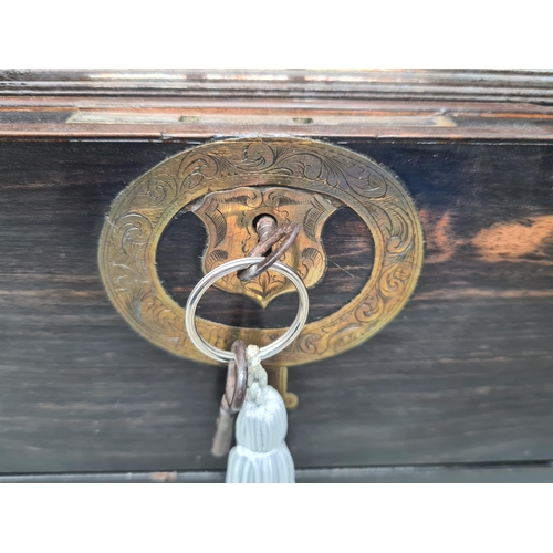 36 - An early 19th century coromandel Dressing case with brass mounts, cartouche and escutcheon, numerous... 