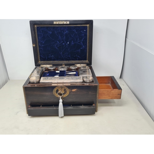 36 - An early 19th century coromandel Dressing case with brass mounts, cartouche and escutcheon, numerous... 