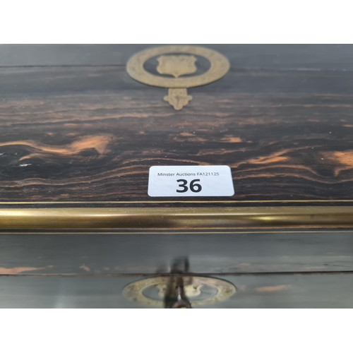 36 - An early 19th century coromandel Dressing case with brass mounts, cartouche and escutcheon, numerous... 