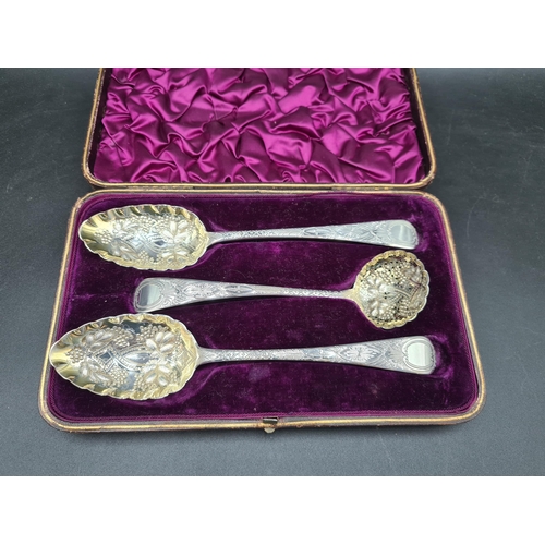 42 - A pair of George III silver Berry Spoons and Sifting Ladle with embossed bowls and engraved stems, L... 
