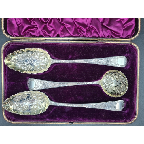 42 - A pair of George III silver Berry Spoons and Sifting Ladle with embossed bowls and engraved stems, L... 