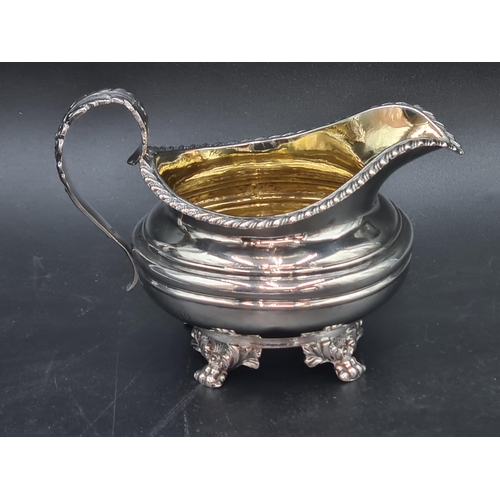 44 - A William IV silver circular Milk Jug with gadroon rim, leafage scroll handle on  paw feet, London 1... 