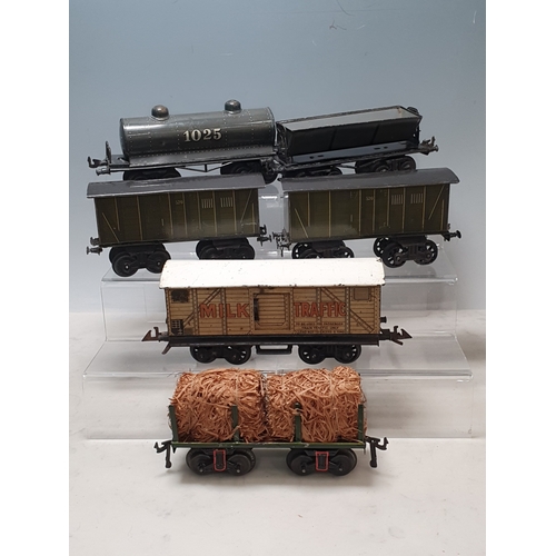 426 - Six Bing 0 gauge Bogie Wagons comprising 2x 520 Goods Vans, Milk Traffic Van, 1025 Tanker, Straw Fla... 