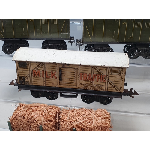 426 - Six Bing 0 gauge Bogie Wagons comprising 2x 520 Goods Vans, Milk Traffic Van, 1025 Tanker, Straw Fla... 