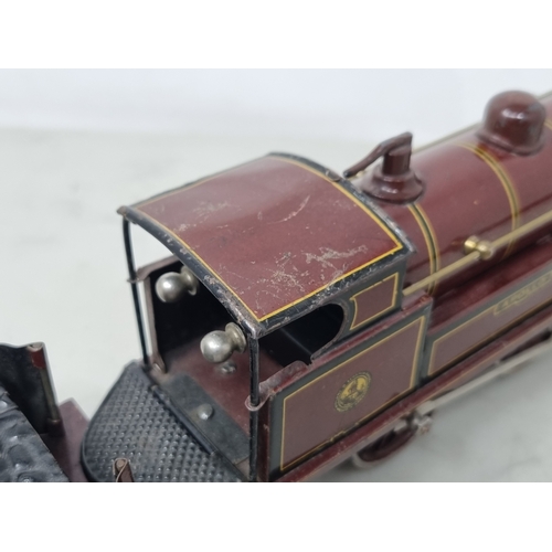 454 - A Bing 0 gauge clockwork LMS Maroon 0-4-0 Locomotive and tender 'Apollo' No.513, VG-Ex