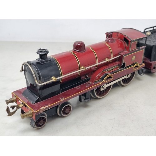 481 - A Bing 0 gauge clockwork LMS maroon 4-4-0 Locomotive and Tender 'Apollo', generally VG, appears in g... 