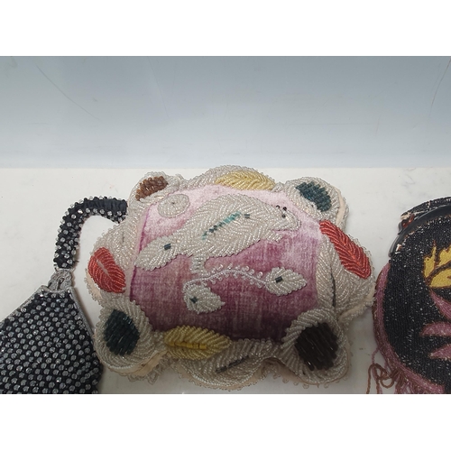 12 - A beadwork Cushion with floral and leaf designs, 10in, and five various beadwork Purses,