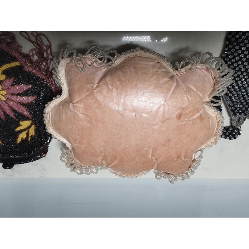 12 - A beadwork Cushion with floral and leaf designs, 10in, and five various beadwork Purses,