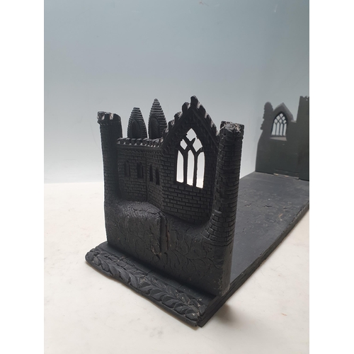 32 - An Irish bog oak Book Stand with folding ends in the form of castle walls, 18 1/2in W, another foldi... 