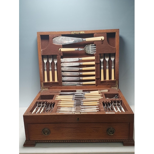 34 - An oak Canteen by Walker & Hall containing plated Cutlery and a set of six silver bean-handled Coffe... 