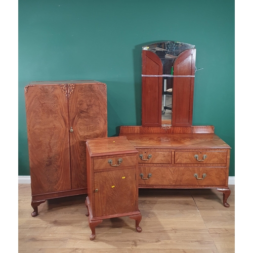 36 - A vintage walnut bedroom suite comprising of a mirror back dressing table, two door wardrobe and a b... 