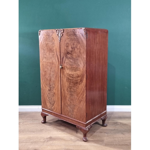36 - A vintage walnut bedroom suite comprising of a mirror back dressing table, two door wardrobe and a b... 