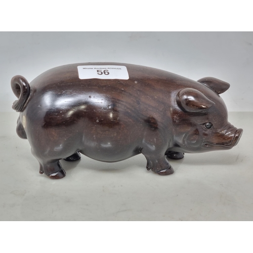 56 - An Oriental carved hardwood Boar with signature on an inset white metal panel, 6in CAB