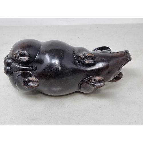 56 - An Oriental carved hardwood Boar with signature on an inset white metal panel, 6in CAB