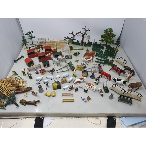 60 - An extensive Collection of painted alloy Farmyard Figures including horses, implements, fences, bell... 