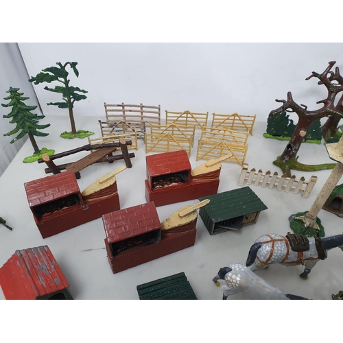 60 - An extensive Collection of painted alloy Farmyard Figures including horses, implements, fences, bell... 