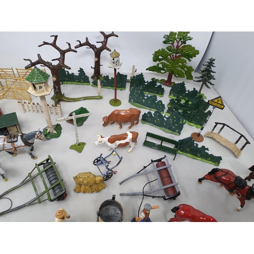 60 - An extensive Collection of painted alloy Farmyard Figures including horses, implements, fences, bell... 